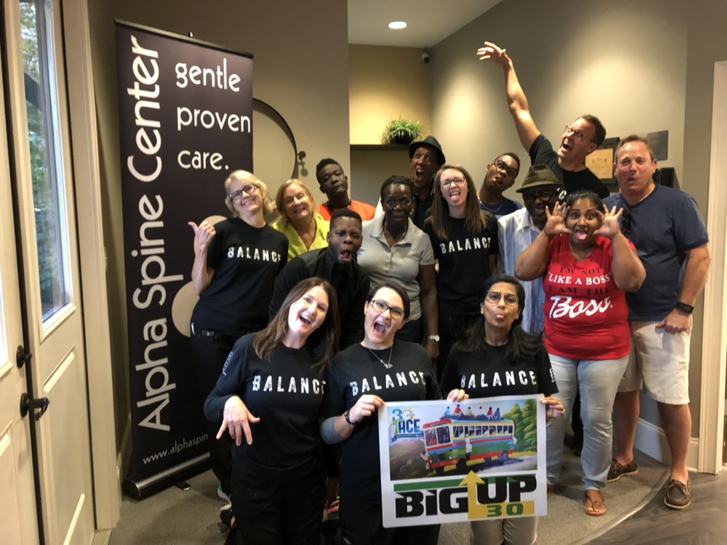 Alpha Spine Center team and ACE visitors enjoying a group photo at the office