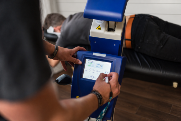 M6 laser controls being set for a patient; office background digitally edited.